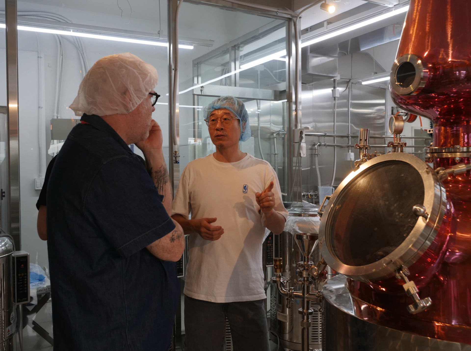 Master distiller explaining traditional soju-making process in modern distillery
