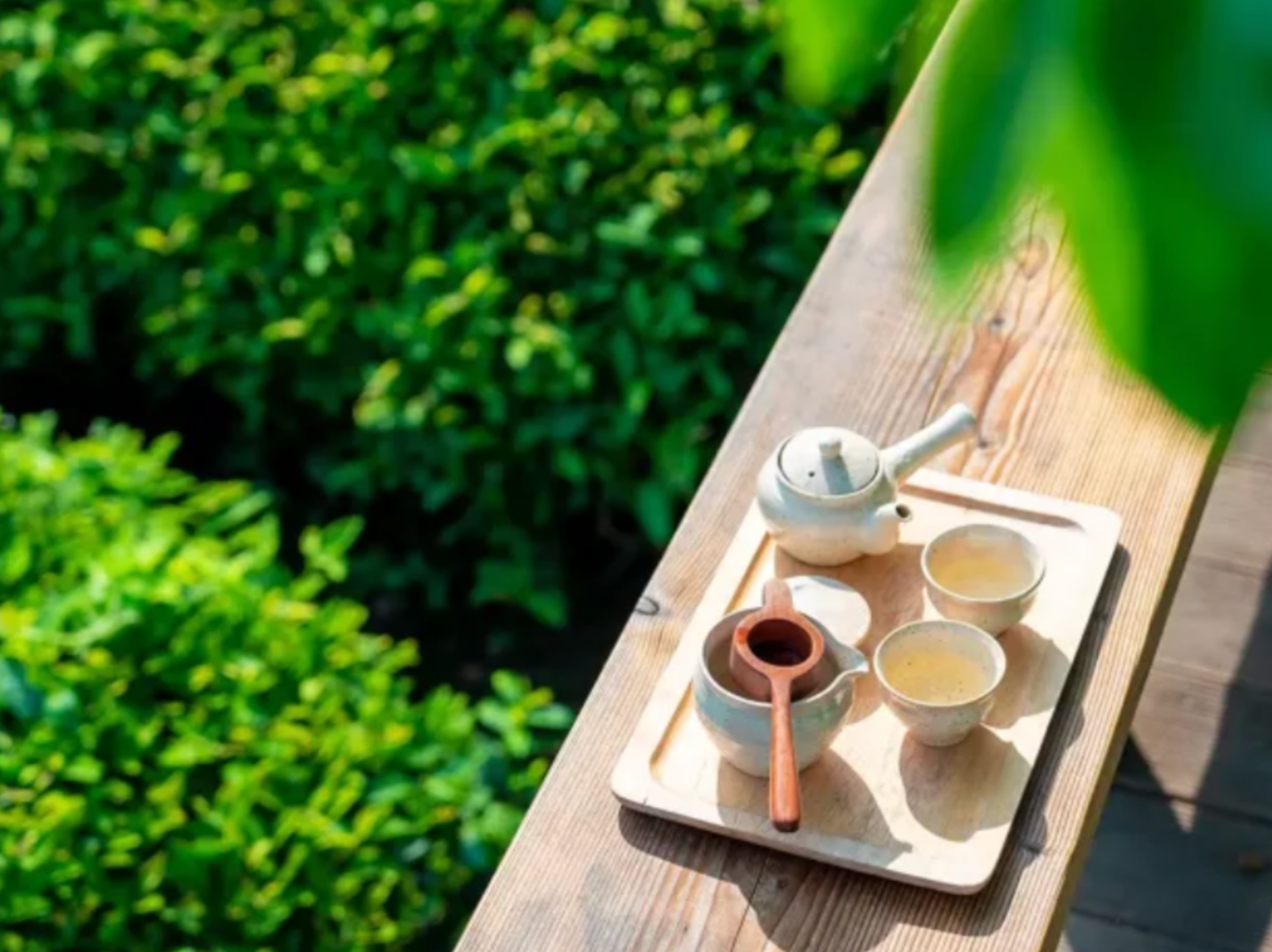 Traditional Korean tea ceremony set with ceramic teapot and cups in serene garden setting