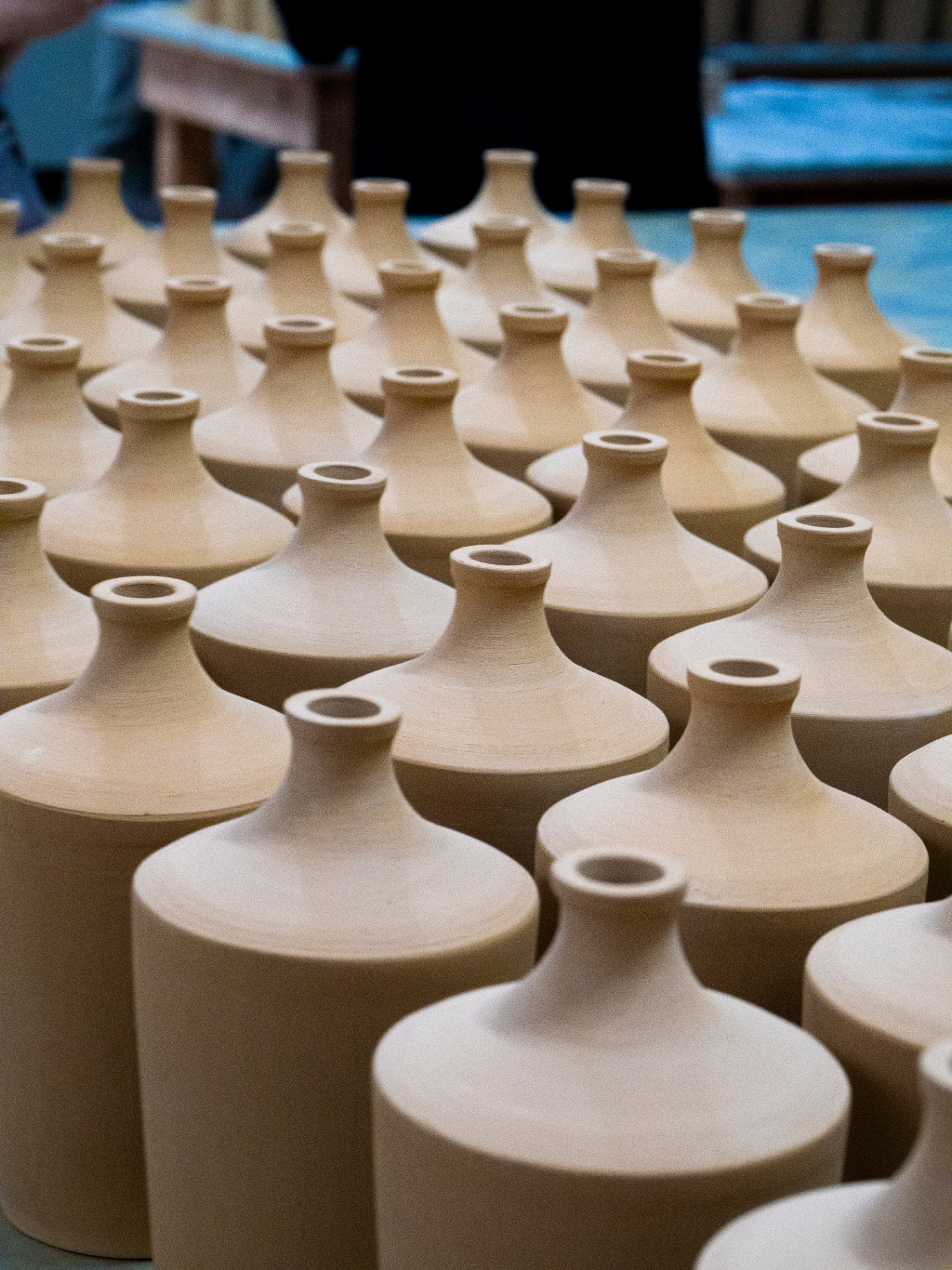 Rows of handcrafted ceramic pottery vessels ready for traditional Korean fermentation and soju aging process