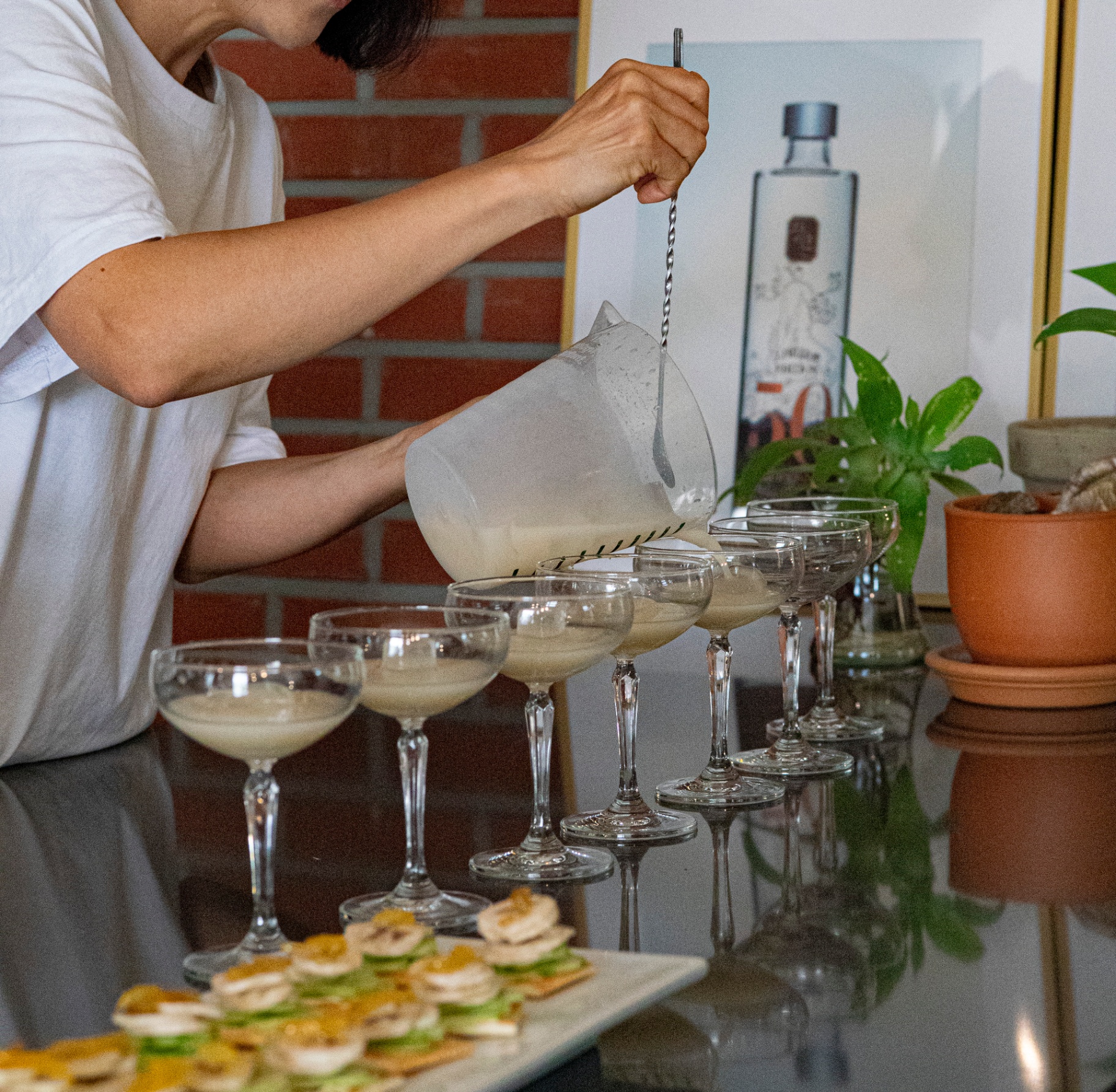 Elegant cocktail preparation with premium Korean spirits poured into sophisticated glassware