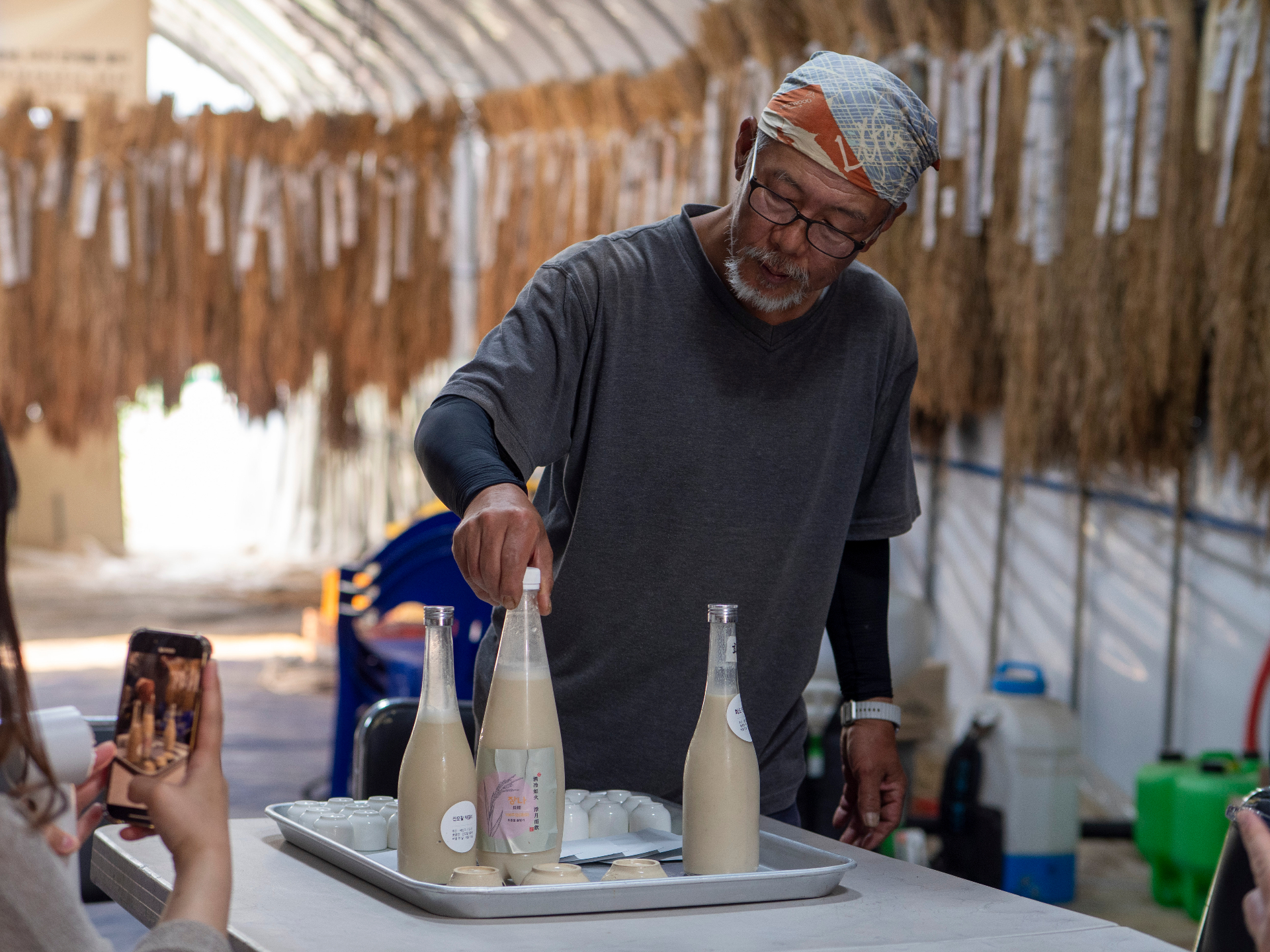 Makgeolli master with traditional bottles