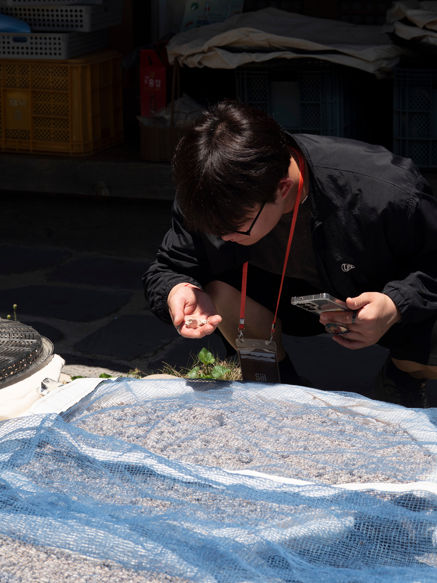 Traditional fermentation master examining ingredients with careful attention to detail